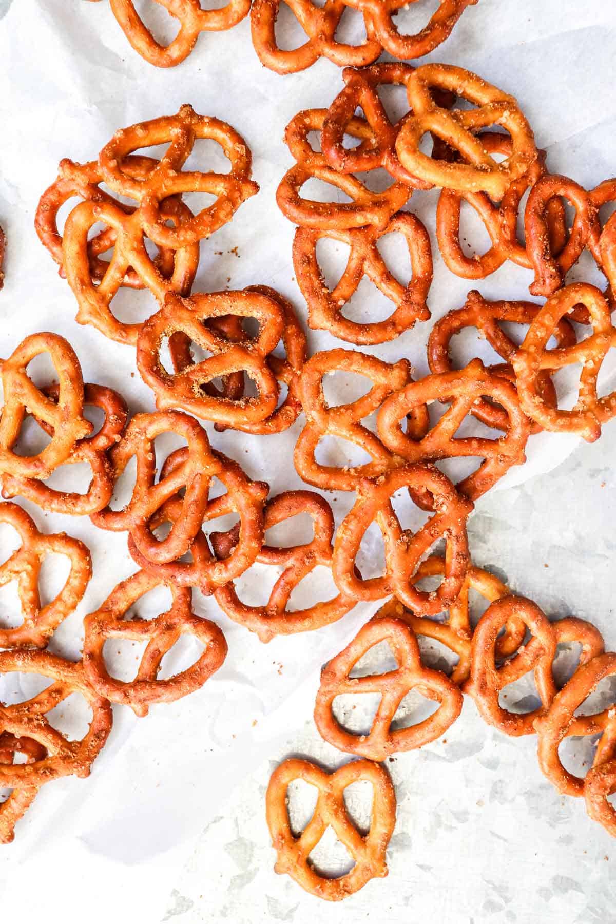 A huge pile of Air Fryer Garlic and Onion Pretzels on a white marble background