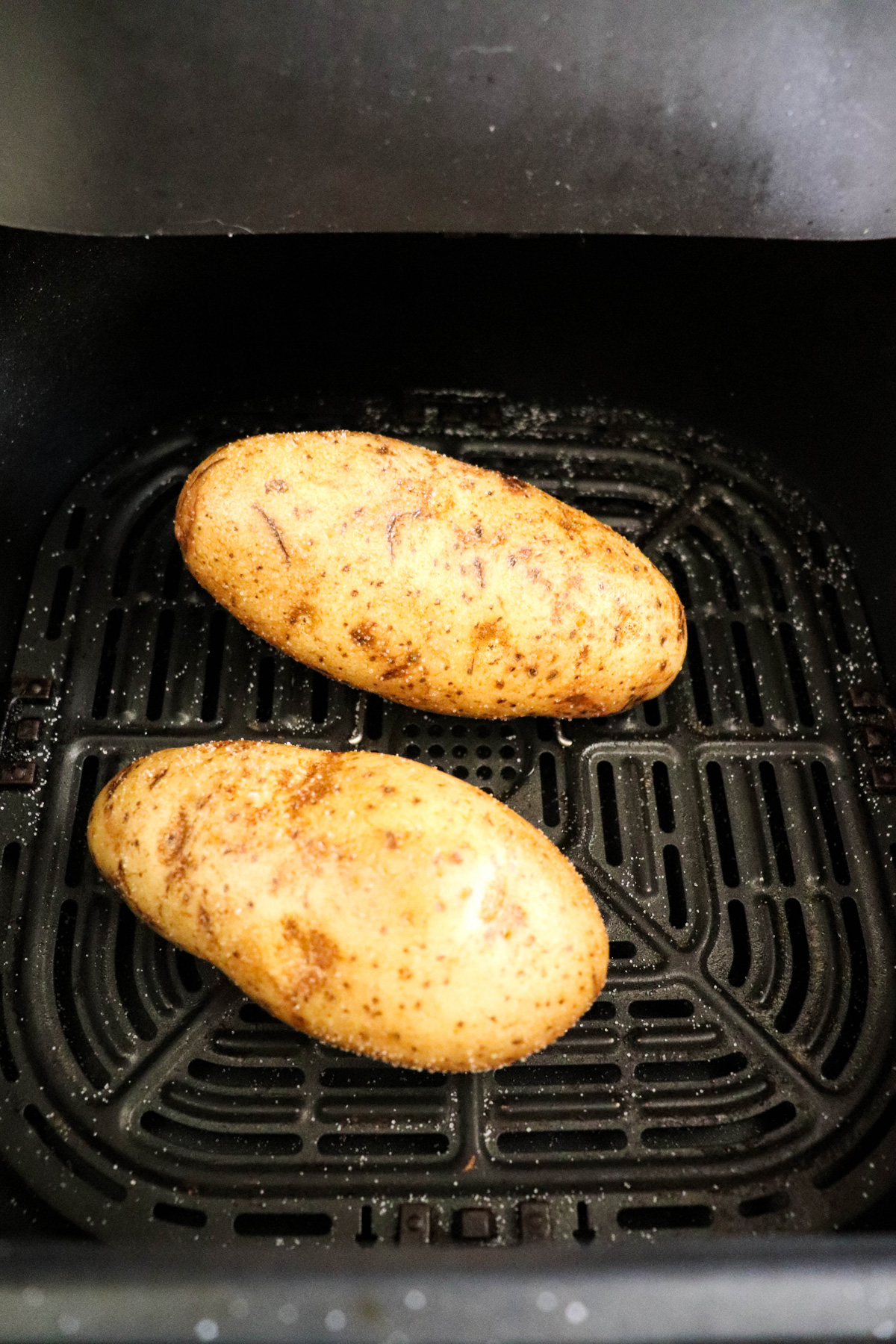 Air Fryer Baked Potatoes in the Air Fryer Basket
